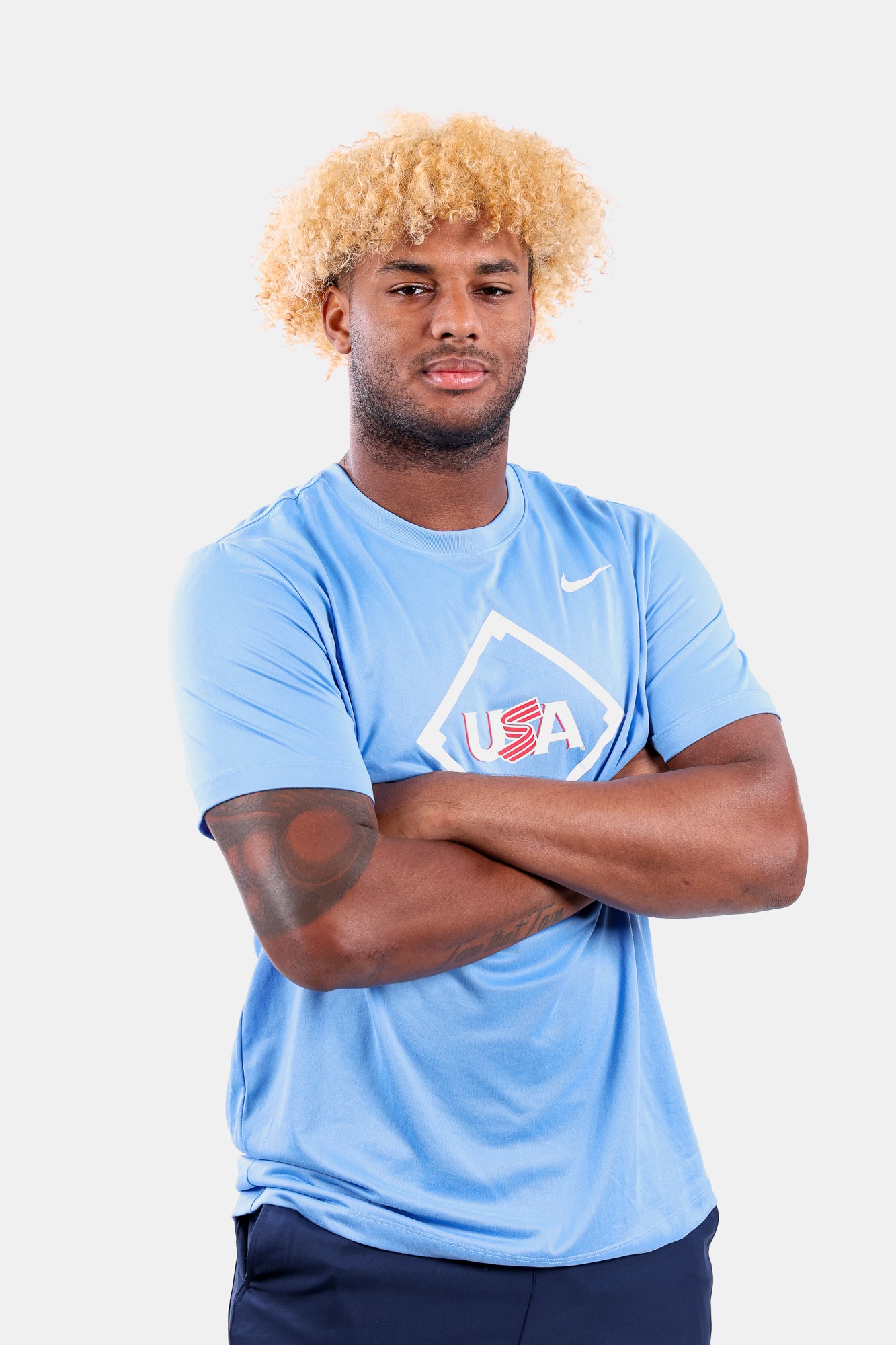 Male model wearing the Light Blue Home Plate Legend Tee featuring the USA Baseball Jersey logo