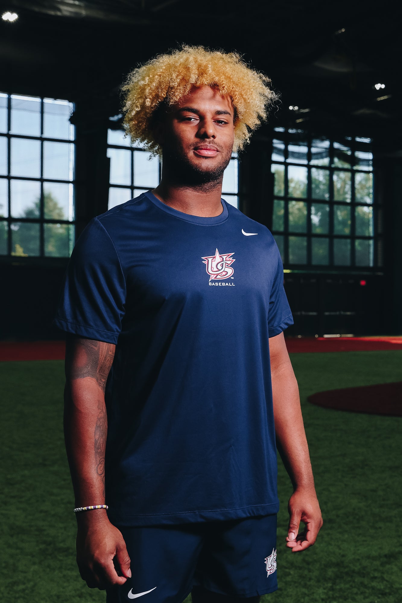 Male model wearing Navy Legend Tee in Indoor Training Facility