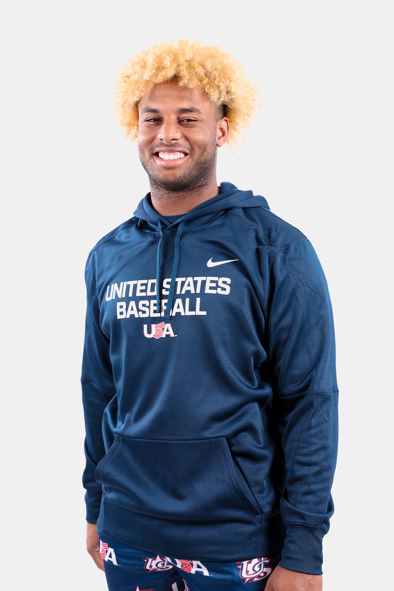 Male model wearing the Navy Foundation Therma Hoodie featuring the USA Baseball Jersey Logo
