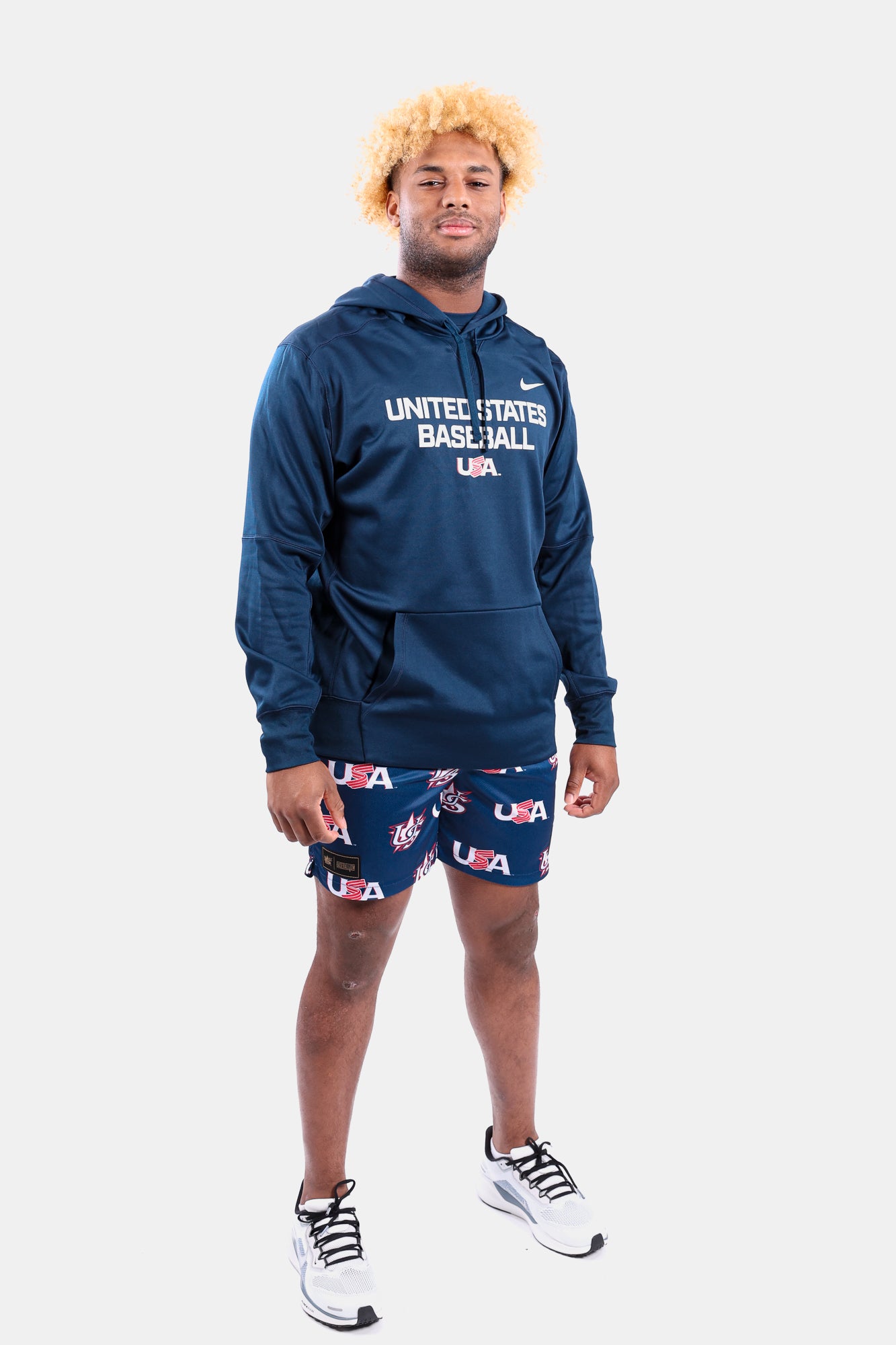 Male model wearing the Navy Foundation Therma Hoodie featuring the USA Baseball Jersey Logo
