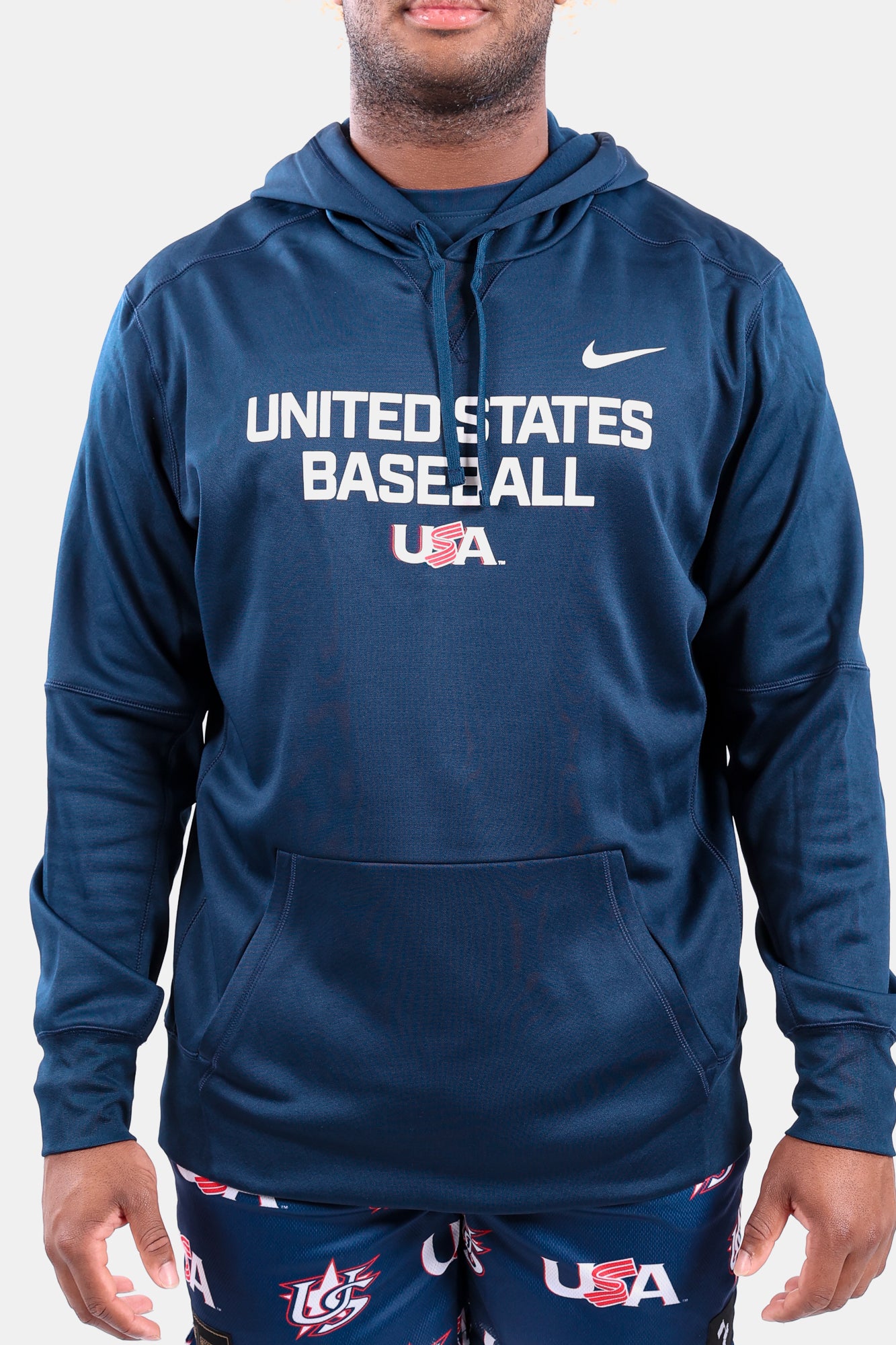Male model wearing the Navy Foundation Therma Hoodie featuring the USA Baseball Jersey Logo
