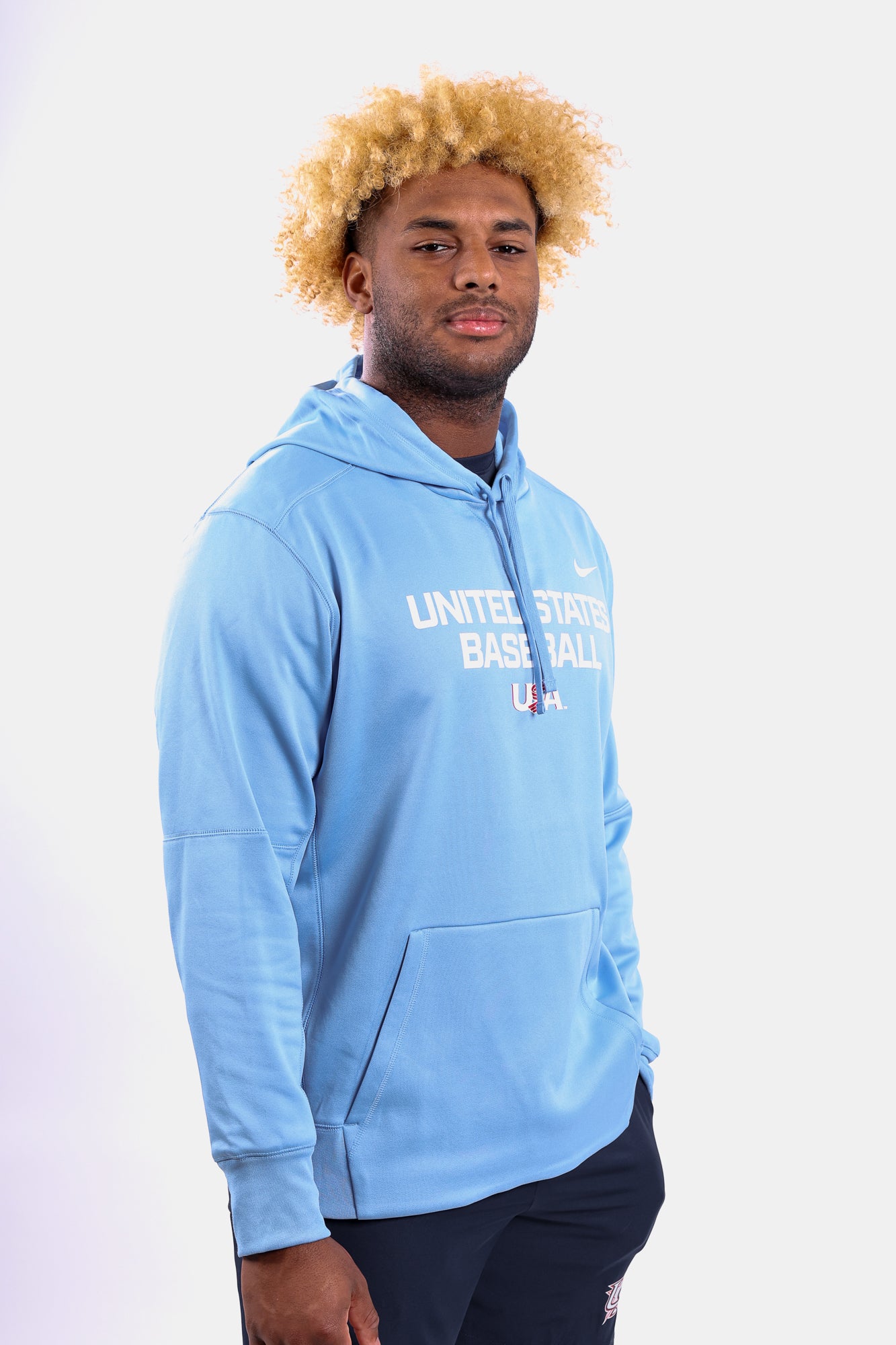 Male model wearing the Light Blue Foundation Therma Hoodie featuring the USA Baseball Jersey Logo
