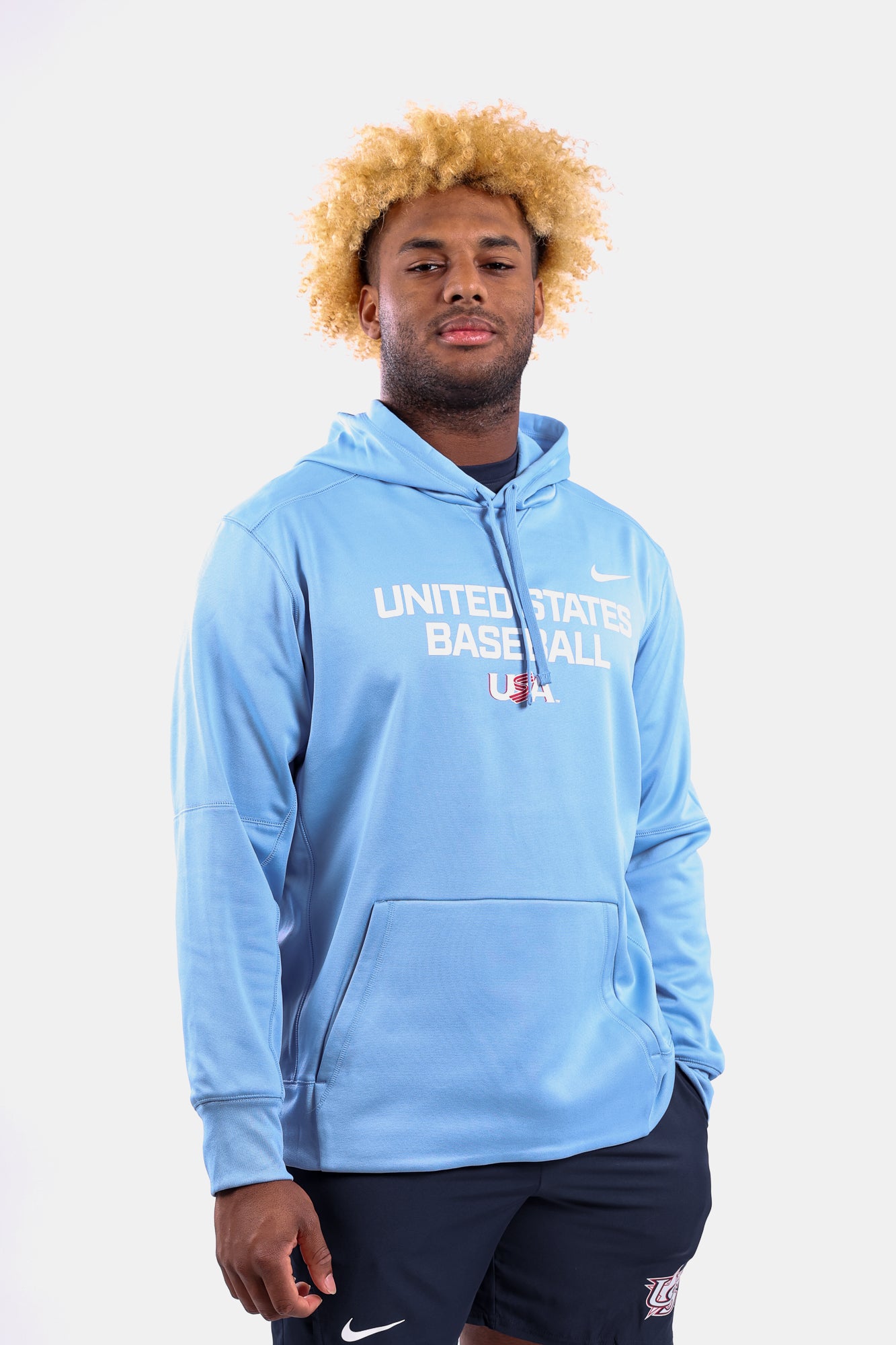 Male model wearing the Light Blue Foundation Therma Hoodie featuring the USA Baseball Jersey Logo