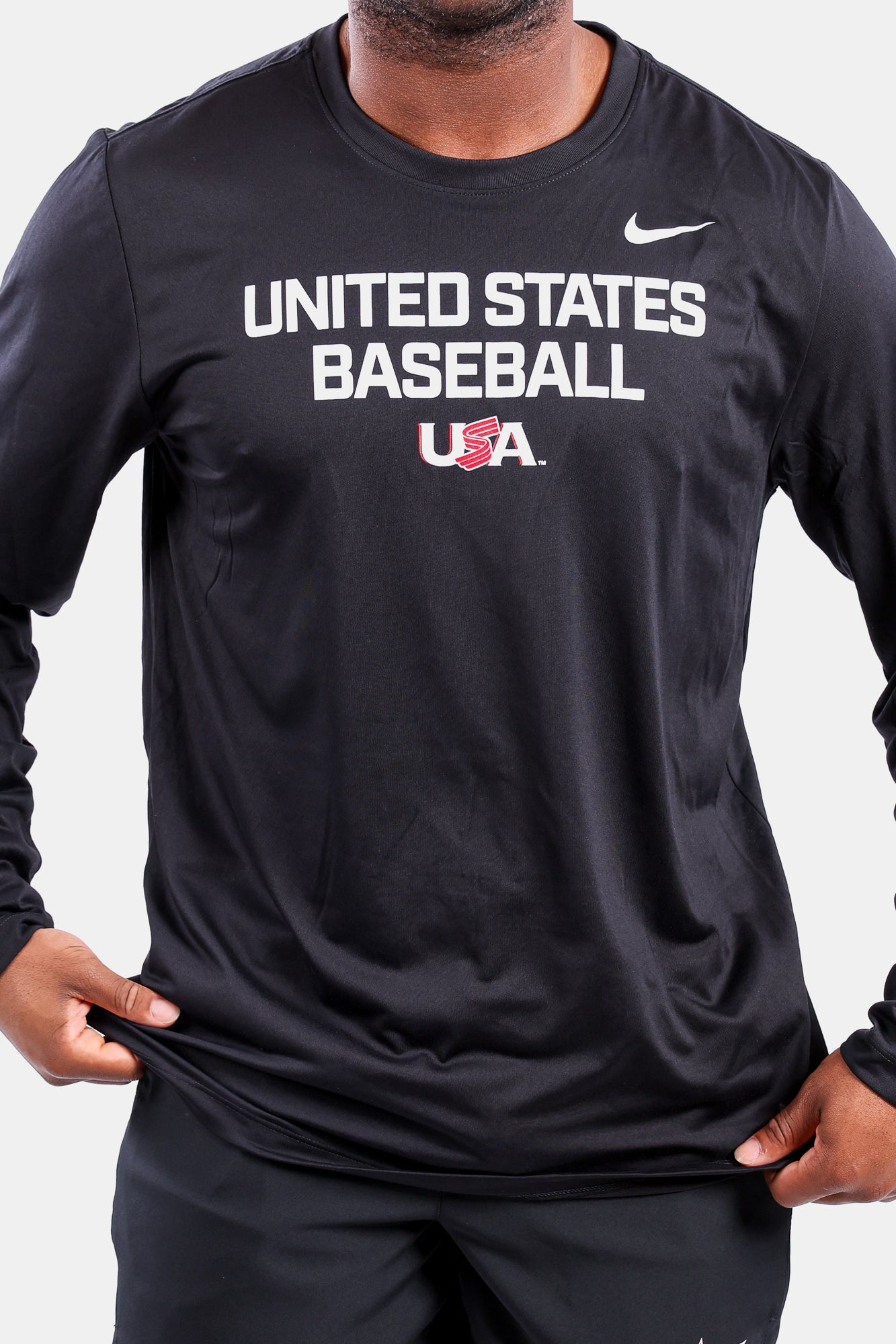 Male model wearing the Black Foundation Long Sleeve Legend Tee featuring the USA Baseball Jersey Logo