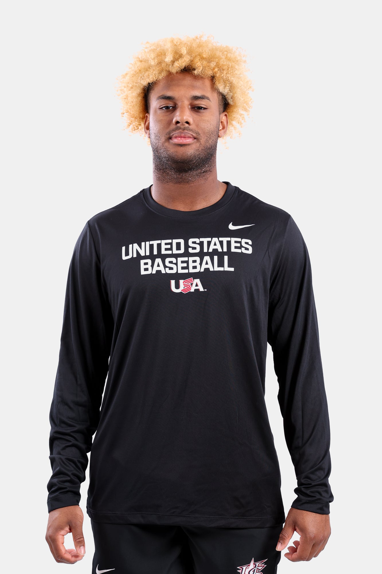 Male model wearing the Black Foundation Long Sleeve Legend Tee featuring the USA Baseball Jersey Logo