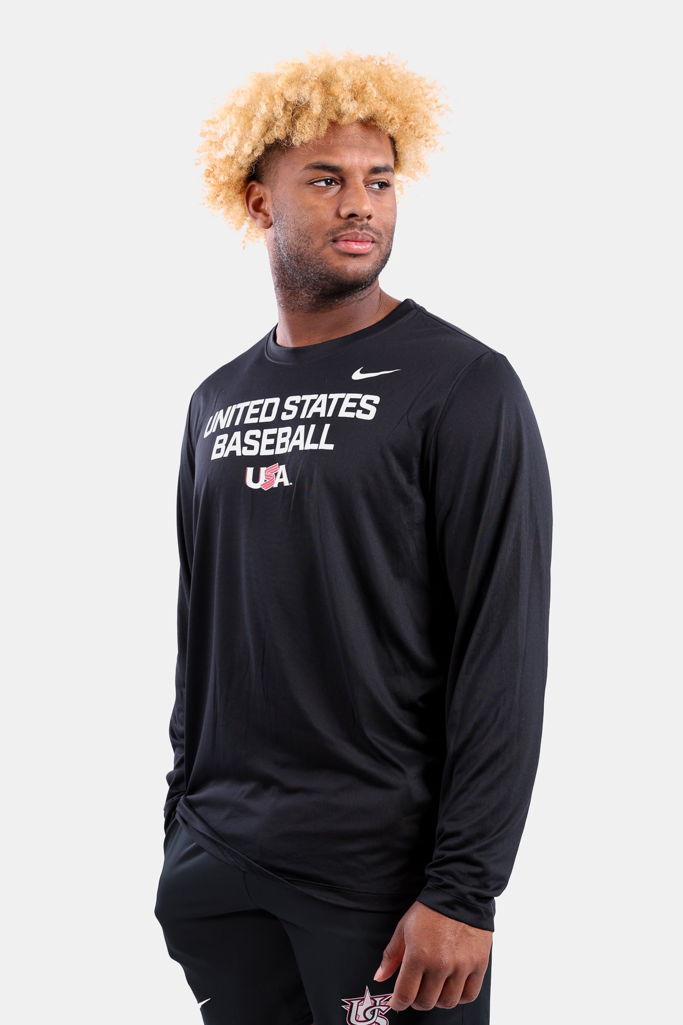 Male model wearing the Black Foundation Long Sleeve Legend Tee featuring the USA Baseball Jersey Logo