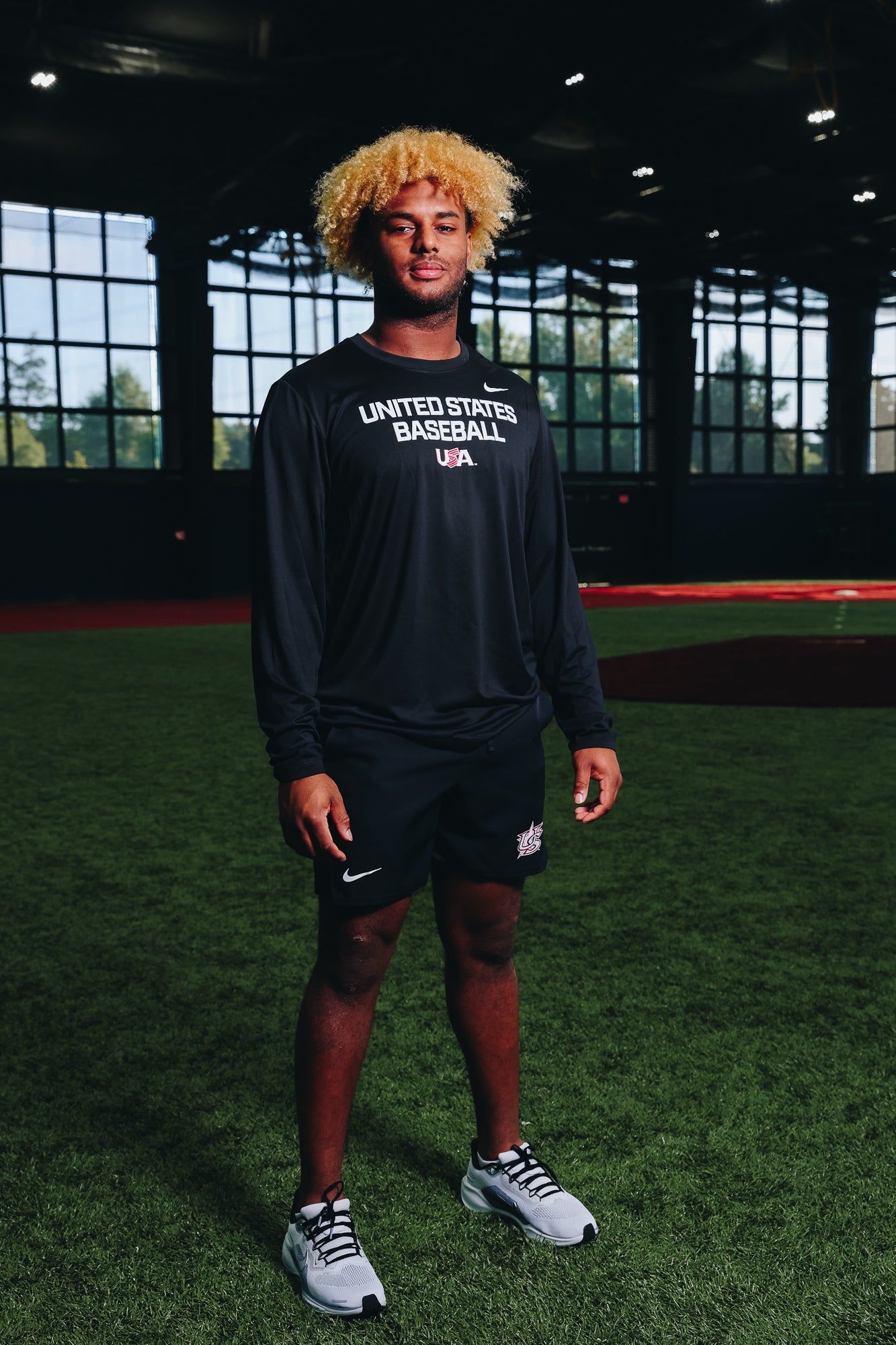 Male model wearing the Black Foundation Long Sleeve Legend Tee featuring the USA Baseball Jersey Logo