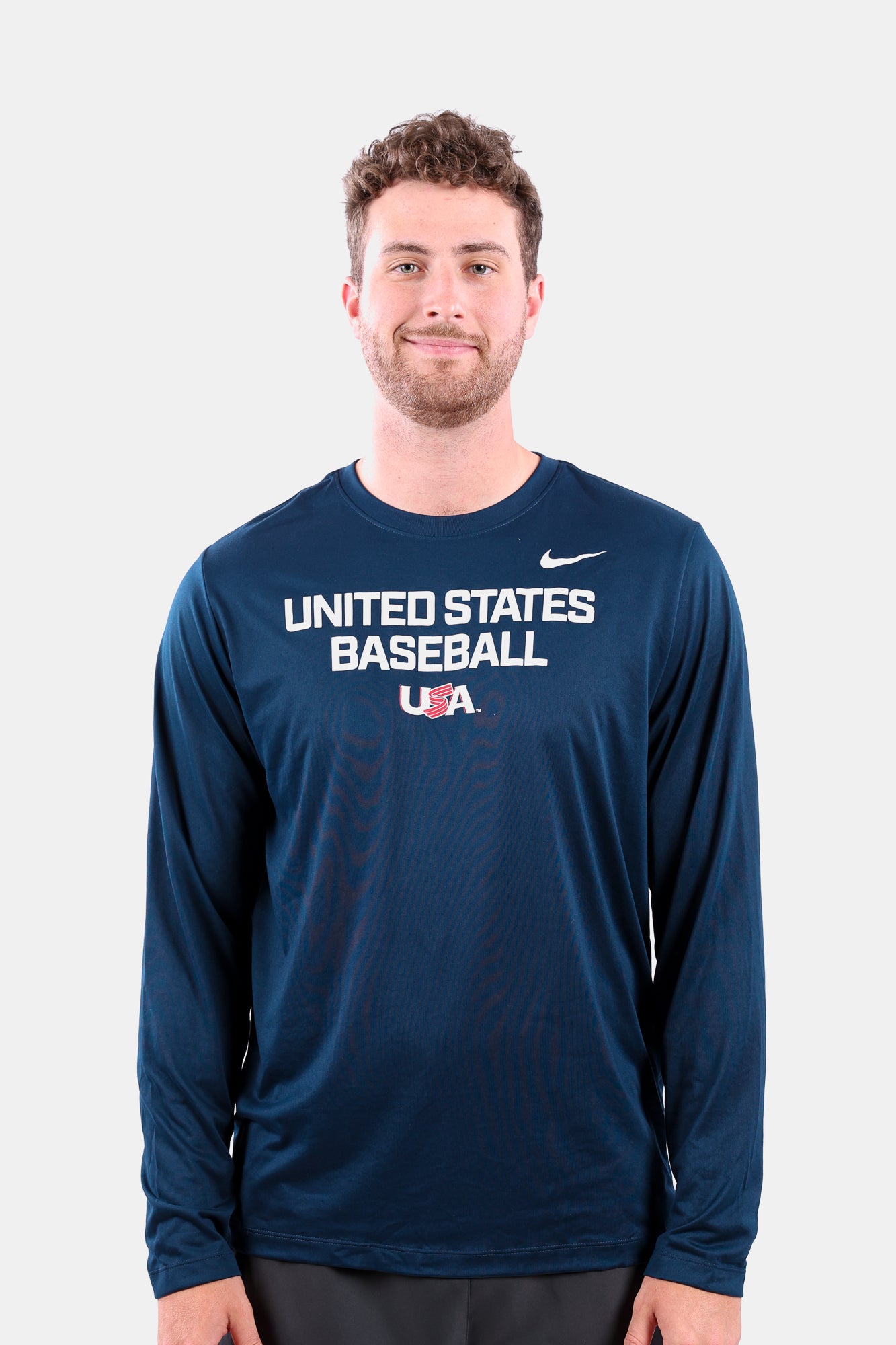 Male model wearing the Navy Foundation Long Sleeve featuring the USA Baseball Jersey Logo