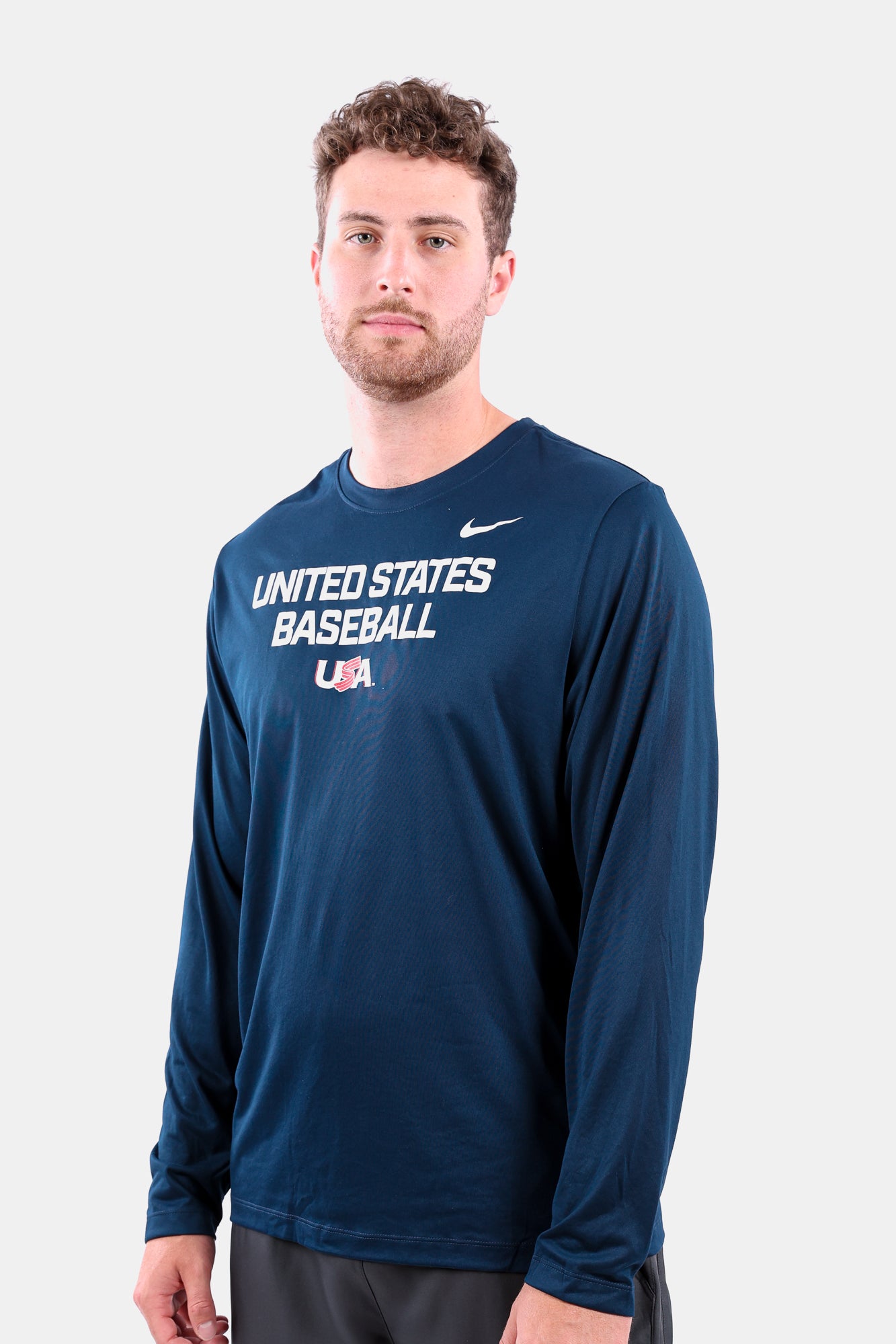 Male model wearing the Navy Foundation Long Sleeve featuring the USA Baseball Jersey Logo