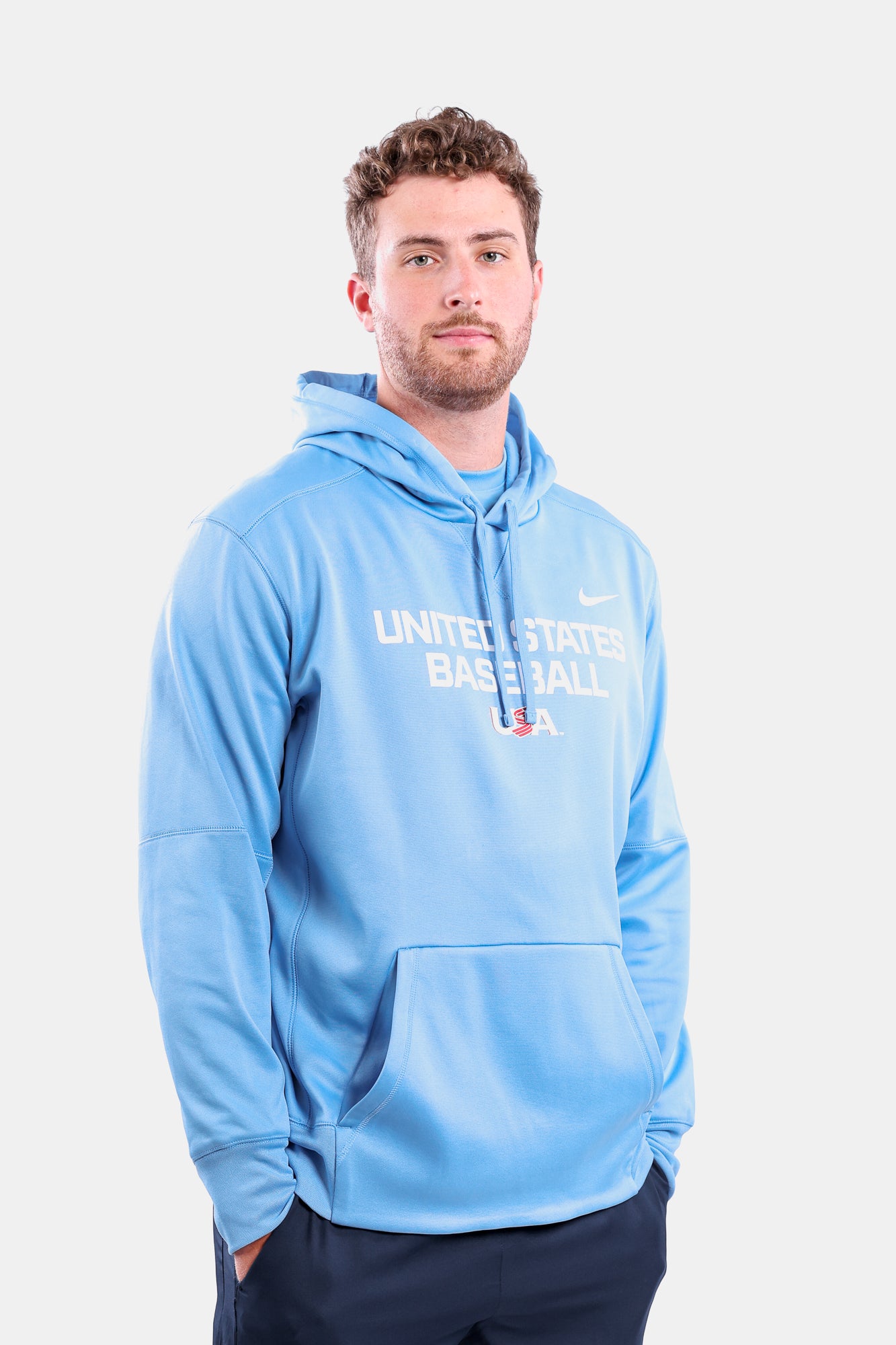 Male model wearing the Light Blue Foundation Therma Hoodie featuring the USA Baseball Jersey Logo