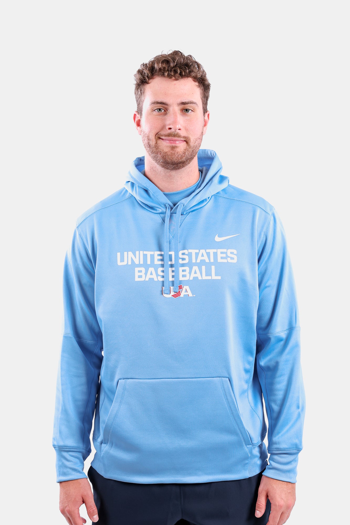 Male model wearing the Light Blue Foundation Therma Hoodie featuring the USA Baseball Jersey Logo