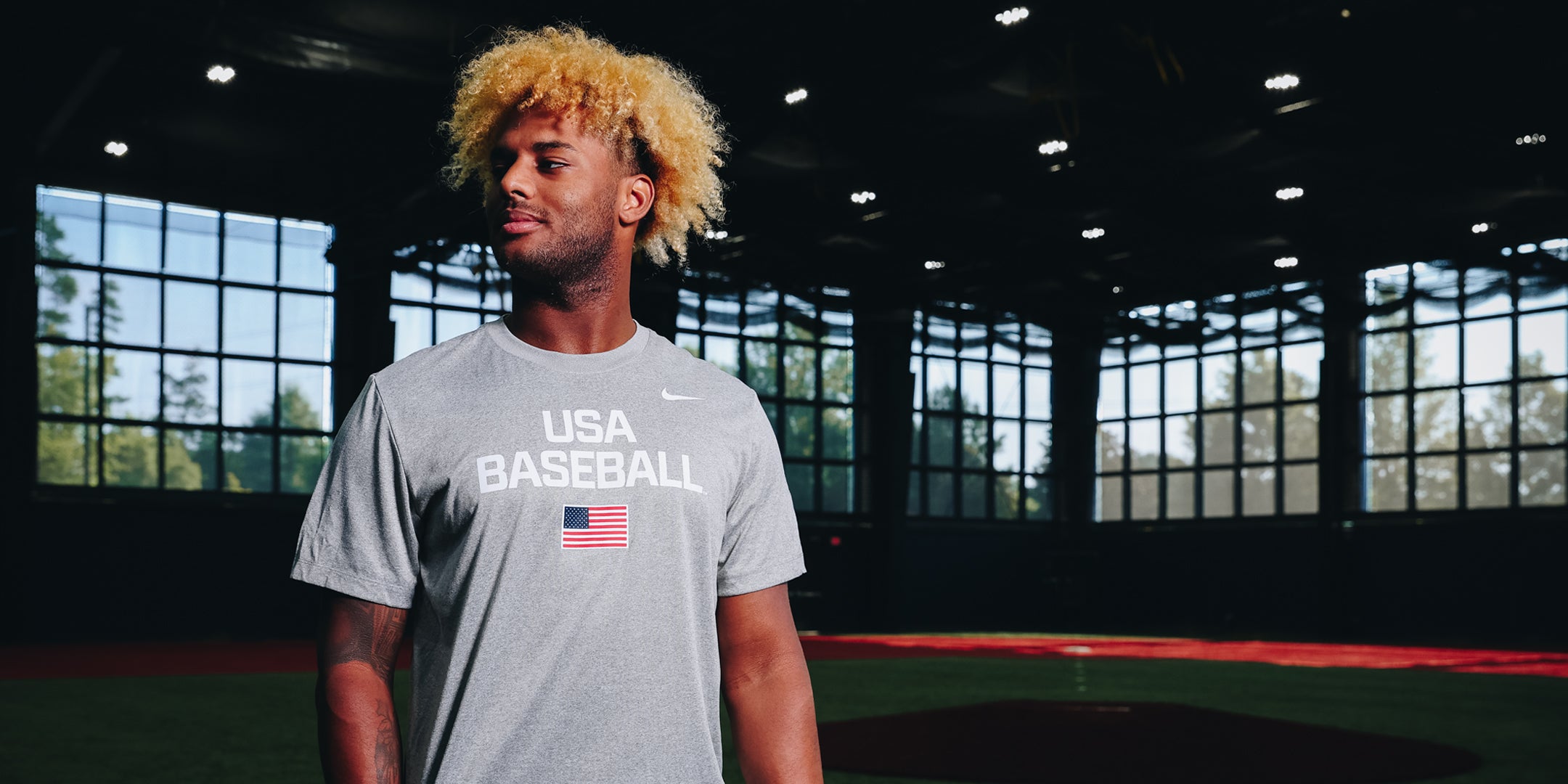 Person wearing a USA Baseball Dynamic tee t-shirt in an indoor sports facility.