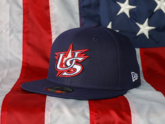 2025 Home Game Cap 59FIFTY featuring the embroidered raised USA Baseball Star logo, sitting on an American flag