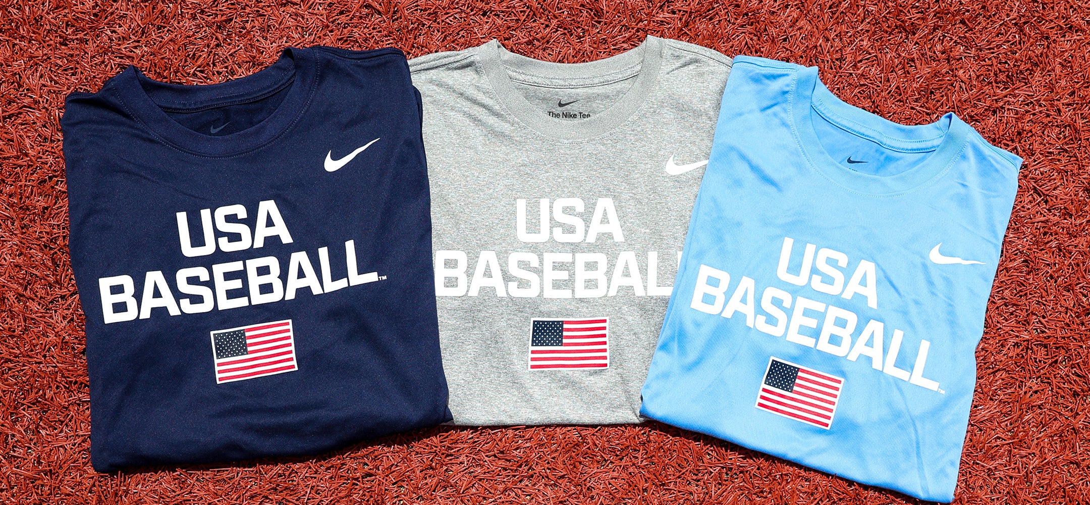 Navy, Heather Grey, and Light Blue Dynamic Legend Tees featuring screen-printed American Flag on turf grass