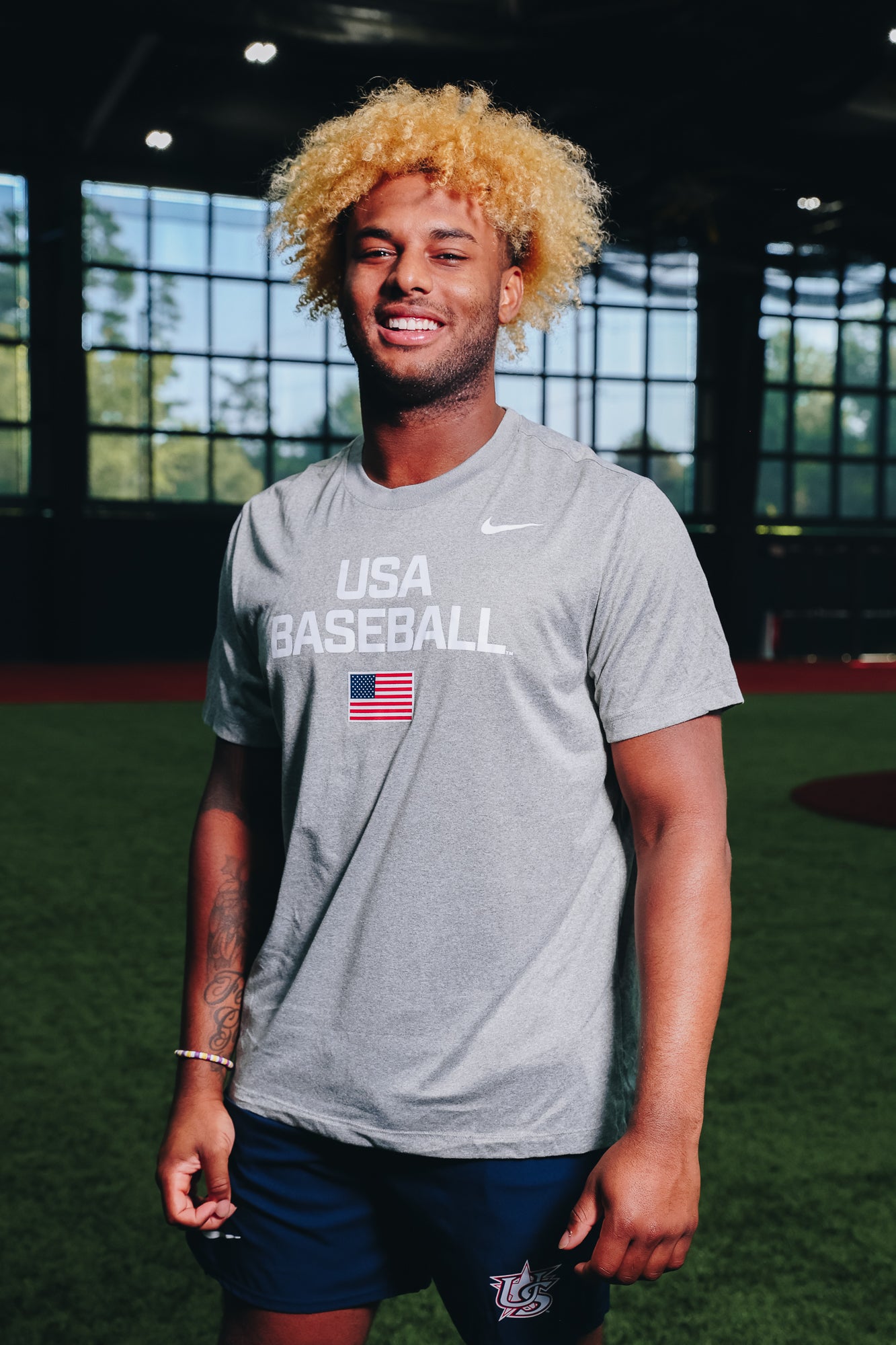 Male model wearing Heather Grey Dynamic Legend Tee in Indoor Training Facility