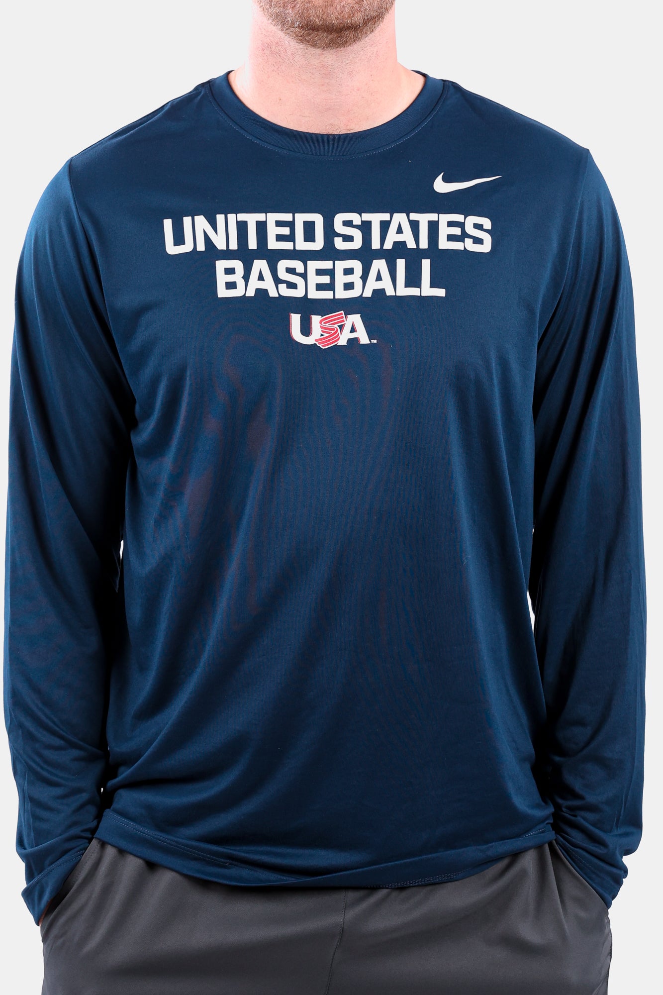 Detail shot of male model wearing the Navy Foundation Long Sleeve featuring the USA Baseball Jersey Logo