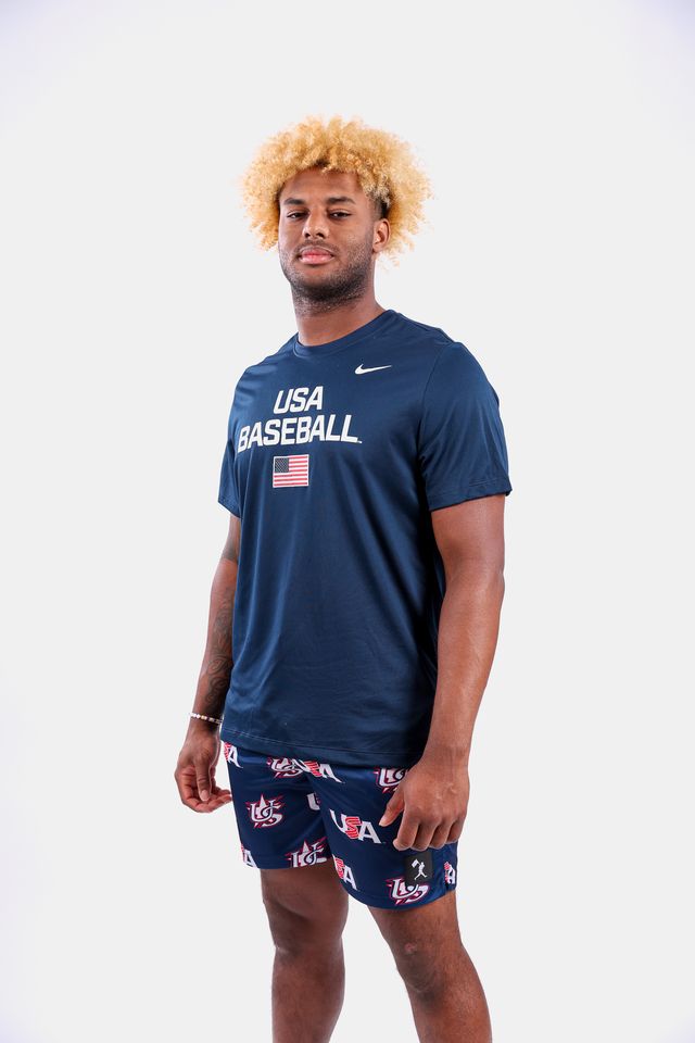 Male model wearing the USA x Baseballism Diamond Air Mesh Shorts with a repeated USA Baseball logo pattern