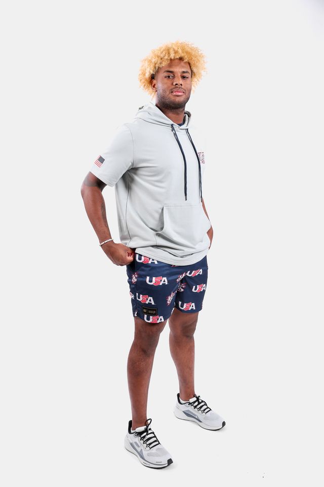 Male model wearing the USA x Baseballism Diamond Air Mesh Shorts with a repeated USA Baseball logo pattern
